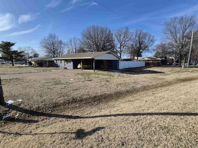 exterior space with fence and a carport