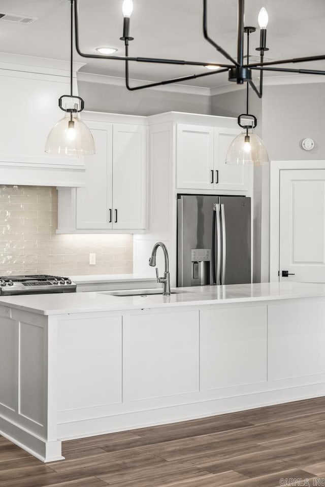 kitchen featuring visible vents, white cabinets, light countertops, stainless steel refrigerator with ice dispenser, and a sink