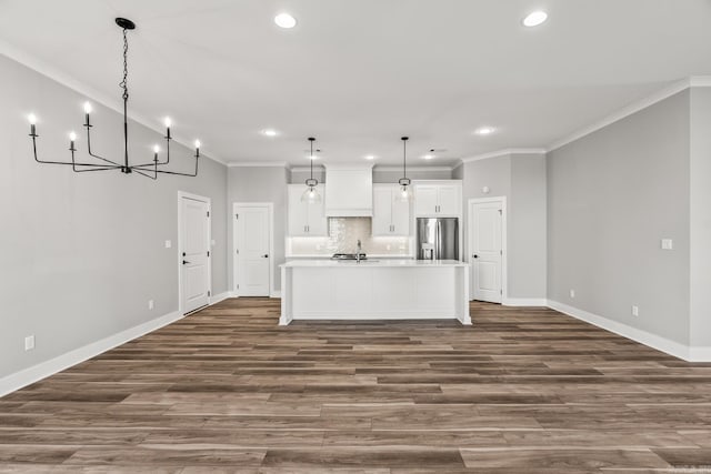 kitchen with white cabinets, ornamental molding, stainless steel refrigerator with ice dispenser, and decorative backsplash