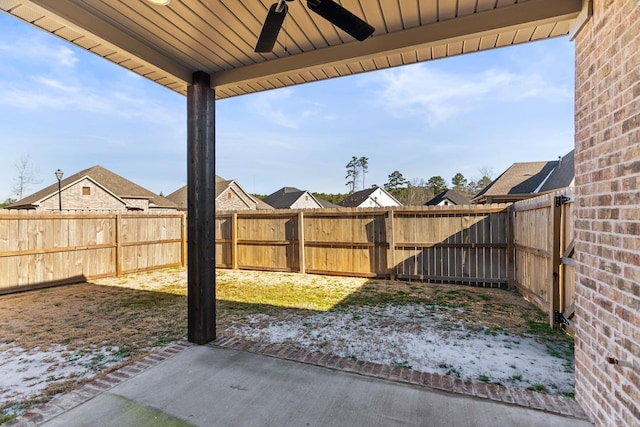 view of yard with a patio, a fenced backyard, and a ceiling fan