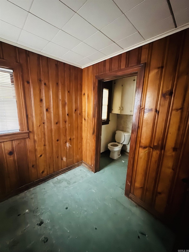 913 W Calhoun, Magnolia, AR 71753 - bathroom featuring wood walls and toilet
