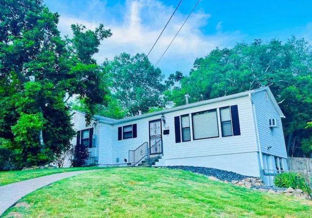 view of front of house with fence and a front yard