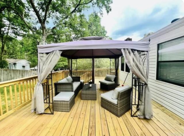 wooden terrace with a gazebo and an outdoor hangout area