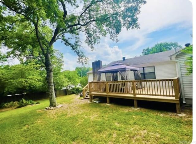 view of yard featuring a deck and a gazebo