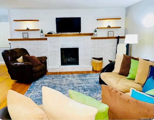 living room featuring a fireplace and wood finished floors