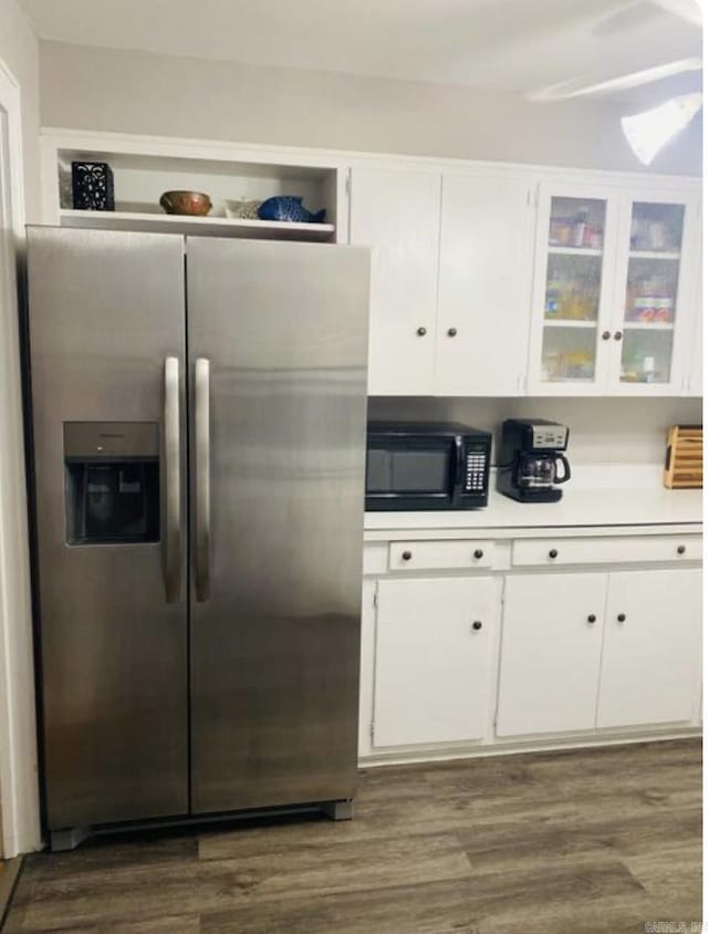 kitchen with white cabinetry, black microwave, light countertops, and stainless steel fridge with ice dispenser