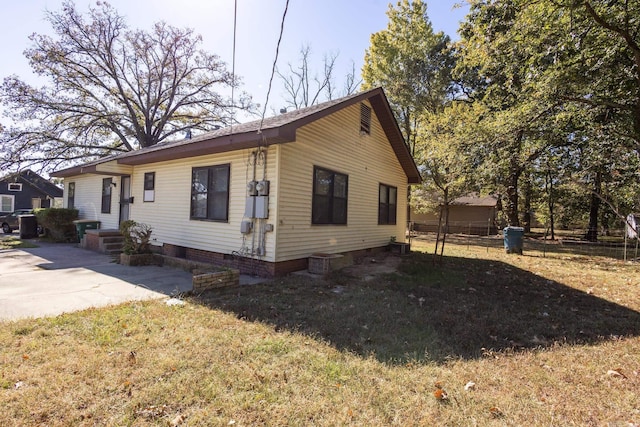 view of home's exterior featuring a yard and fence