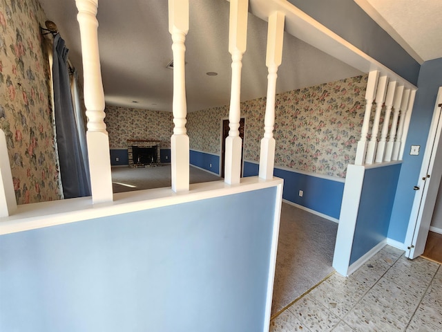 interior space with wainscoting, baseboards, and wallpapered walls