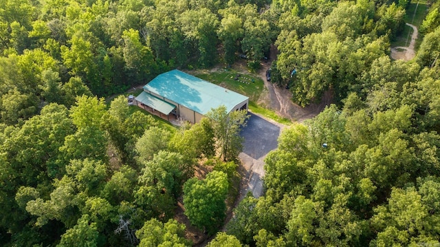 drone / aerial view featuring a view of trees