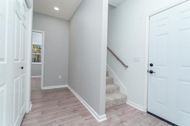 entrance foyer with stairs, recessed lighting, baseboards, and light wood-style floors