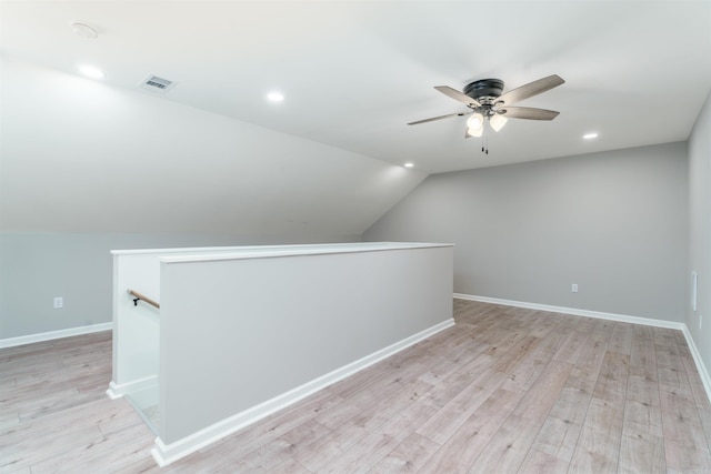 bonus room with lofted ceiling, light wood-style floors, baseboards, and visible vents