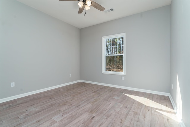 unfurnished room featuring light wood finished floors, baseboards, and visible vents