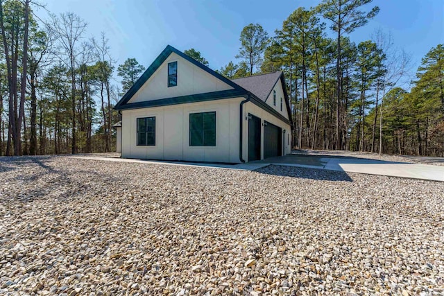 exterior space with a garage and concrete driveway