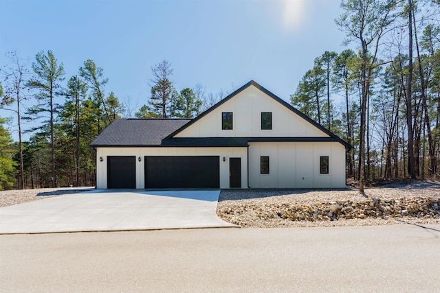 view of front facade with an attached garage, driveway, and roof with shingles