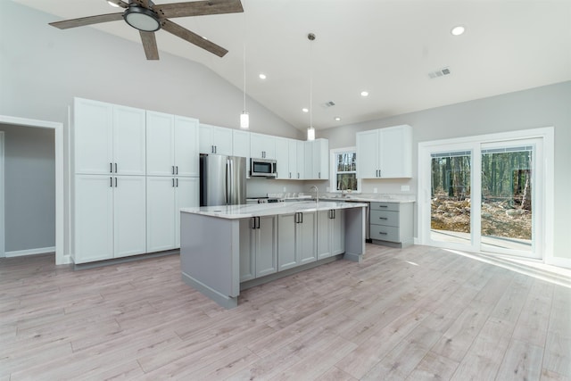 kitchen featuring light wood-type flooring, visible vents, appliances with stainless steel finishes, and light countertops