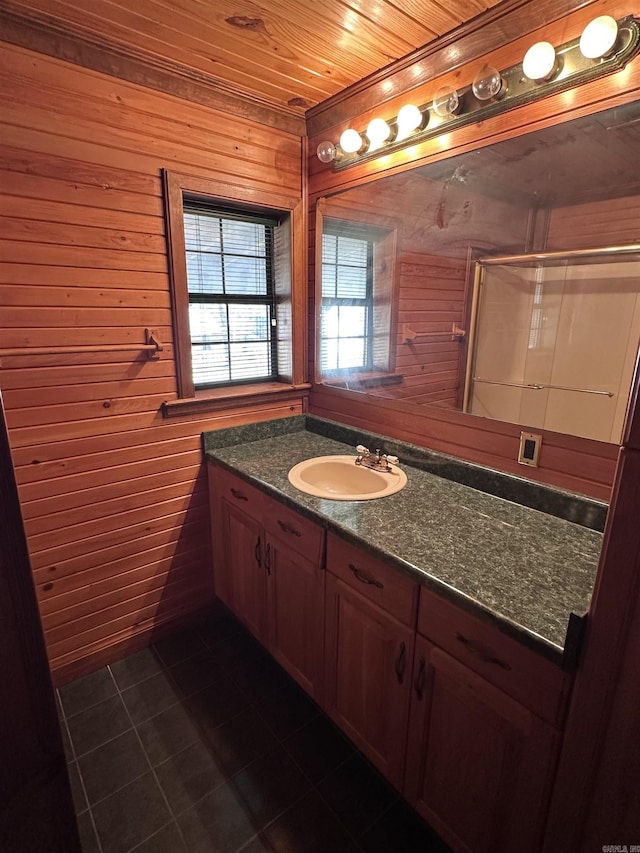 bathroom featuring wooden ceiling, tile patterned floors, a shower with door, and vanity