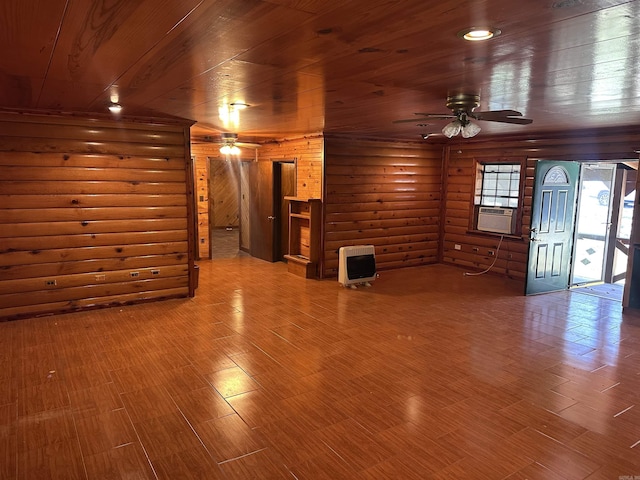 unfurnished living room featuring wood ceiling, ceiling fan, wood finished floors, heating unit, and log walls