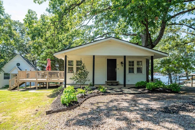 view of front of property with a front yard and a deck