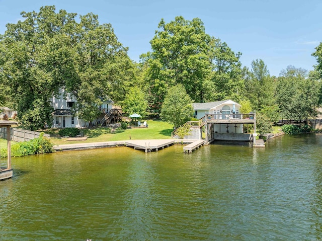 view of dock featuring a water view and a lawn