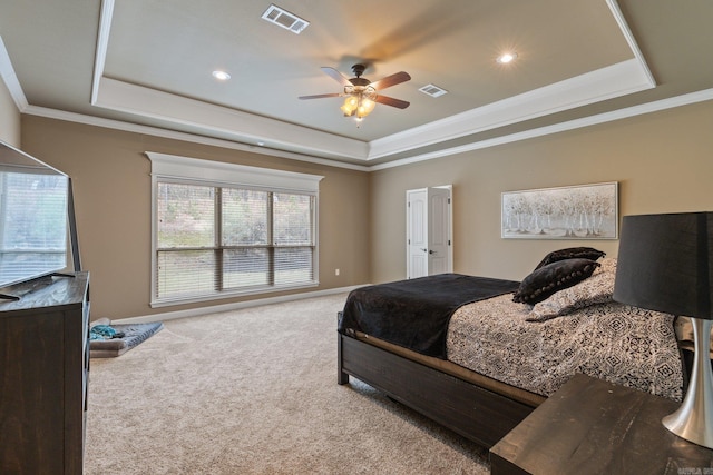 bedroom featuring ornamental molding, carpet, a raised ceiling, and visible vents