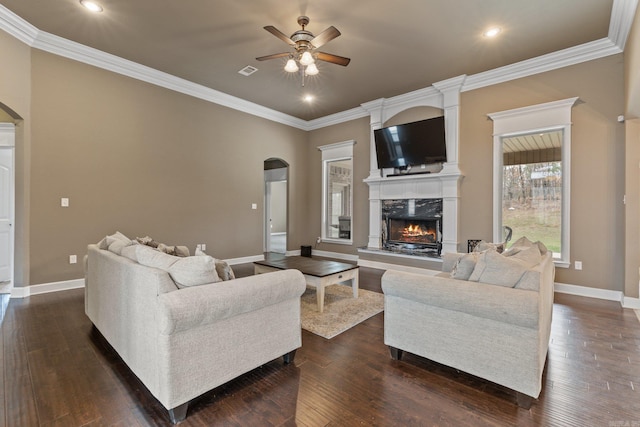 living room featuring arched walkways, a fireplace, dark wood-style floors, and visible vents