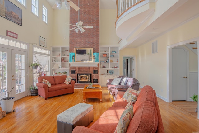 living area with baseboards, visible vents, a ceiling fan, wood finished floors, and french doors