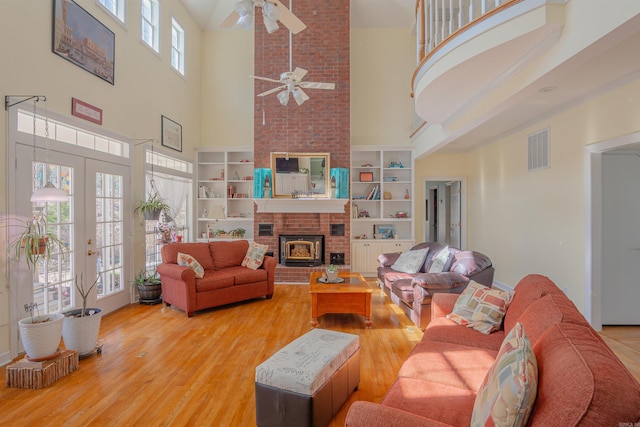 living area featuring a wealth of natural light, french doors, visible vents, and wood finished floors