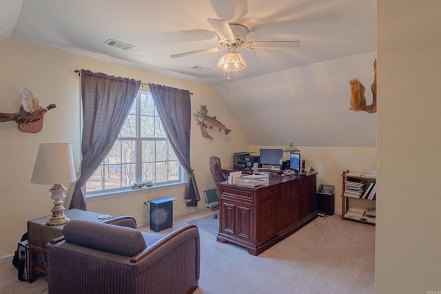 office featuring vaulted ceiling, ceiling fan, visible vents, and light colored carpet