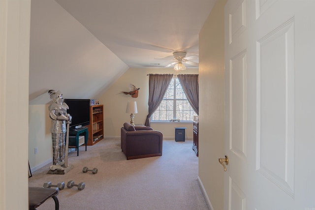 interior space with lofted ceiling, carpet flooring, a ceiling fan, and baseboards