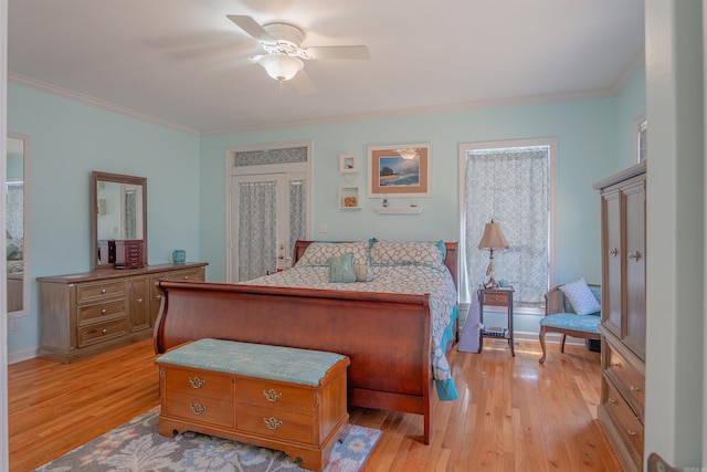 bedroom featuring light wood-style floors, ceiling fan, baseboards, and crown molding