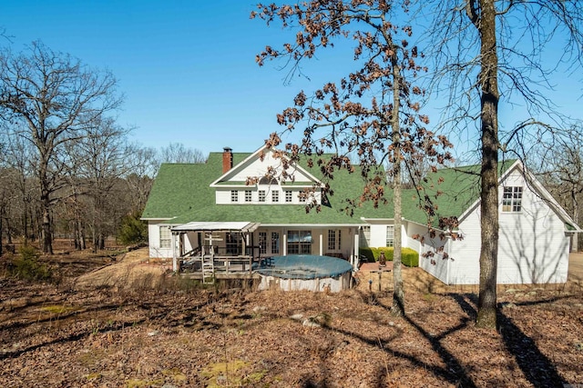 rear view of property with a chimney