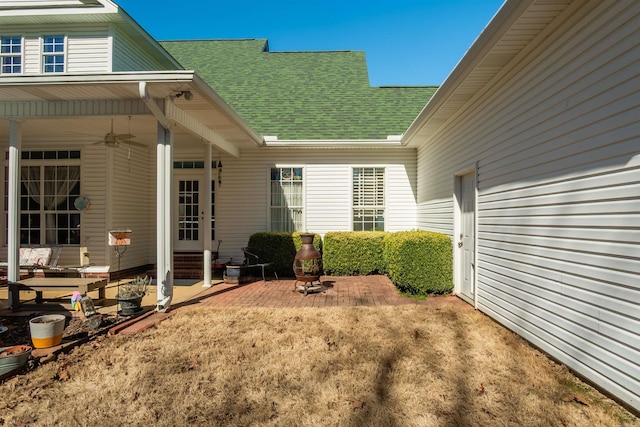 view of yard featuring a ceiling fan, entry steps, and a patio area