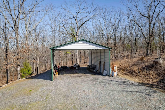 view of parking featuring a carport and gravel driveway