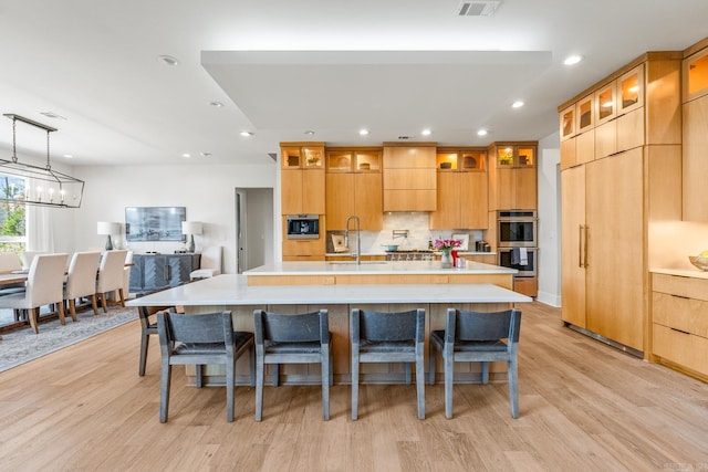 108 Mornay Ln, Little Rock, AR 72223 - kitchen with double oven, a sink, light countertops, and a kitchen breakfast bar