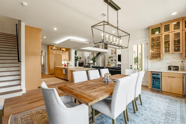 108 Mornay Ln, Little Rock, AR 72223 - dining area featuring wine cooler, light wood-style flooring, recessed lighting, and stairs