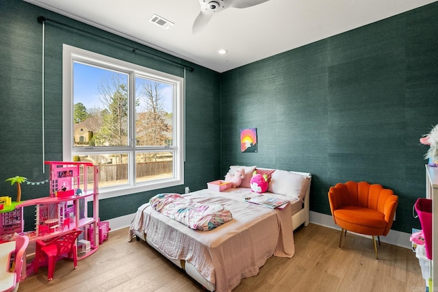 108 Mornay Ln, Little Rock, AR 72223 - bedroom featuring wood finished floors, a ceiling fan, visible vents, baseboards, and wallpapered walls