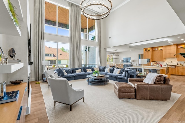 108 Mornay Ln, Little Rock, AR 72223 - living room with a chandelier, light wood finished floors, a towering ceiling, and a wealth of natural light