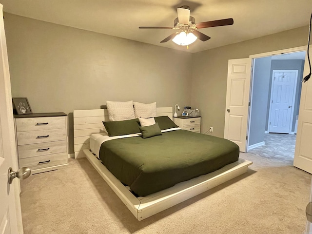 bedroom featuring light carpet, ceiling fan, and baseboards