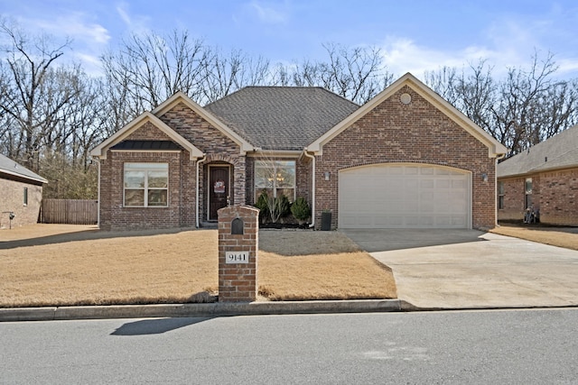 view of front of home with a garage, concrete driveway, stone siding, roof with shingles, and brick siding