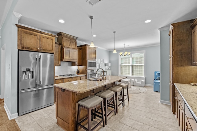 kitchen with stainless steel appliances, a sink, ornamental molding, light stone countertops, and tasteful backsplash