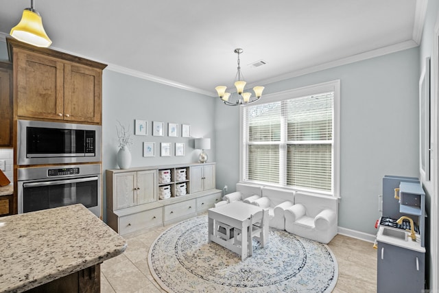 interior space featuring oven, visible vents, hanging light fixtures, built in microwave, and crown molding