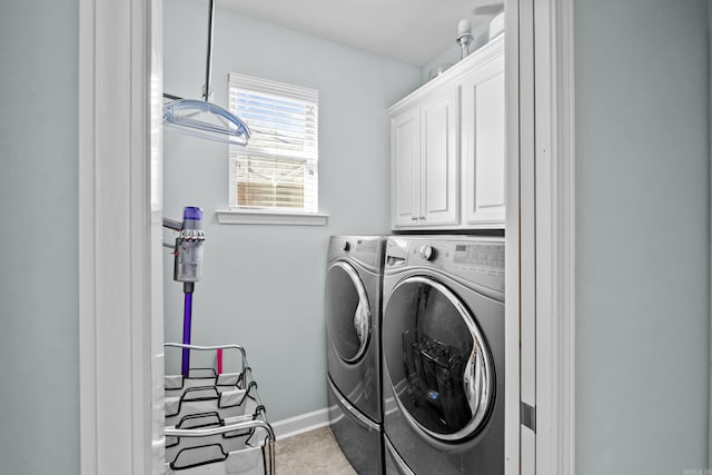 laundry area with cabinet space, baseboards, and separate washer and dryer