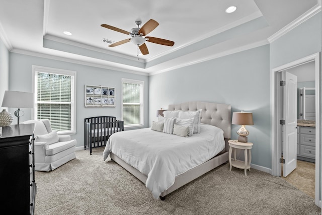 bedroom featuring carpet floors, multiple windows, visible vents, and a raised ceiling