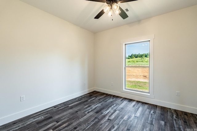 unfurnished room with ceiling fan, dark wood-style flooring, visible vents, and baseboards