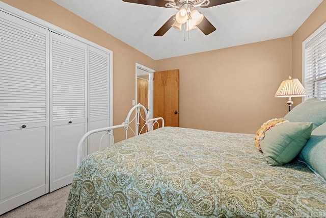 bedroom with a ceiling fan, a closet, and carpet flooring