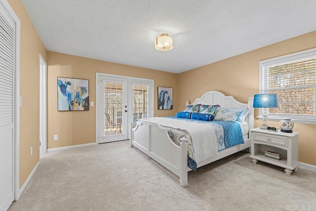 bedroom with baseboards, french doors, access to outside, a textured ceiling, and carpet flooring