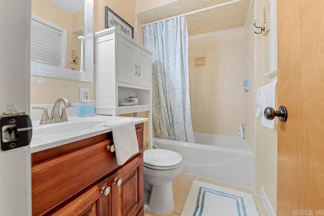 bathroom with toilet, vanity, tile patterned floors, tasteful backsplash, and shower / bath combination with curtain