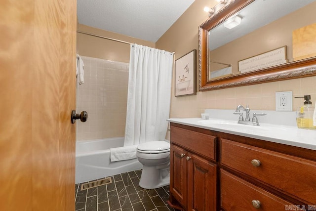 bathroom featuring visible vents, toilet, shower / bath combo with shower curtain, vanity, and tile walls