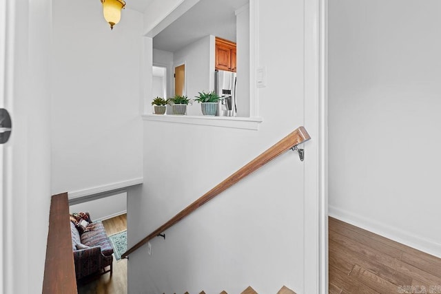 stairs featuring baseboards and wood finished floors