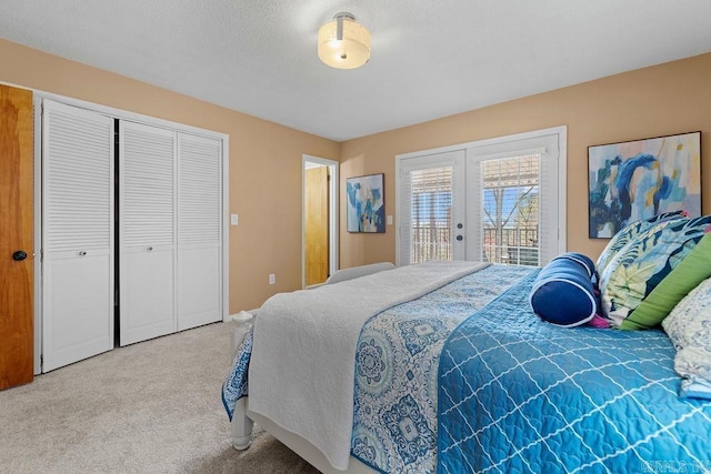 bedroom with carpet floors, access to outside, a closet, and french doors